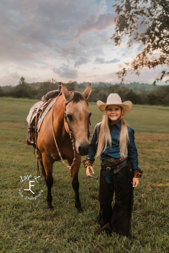 older cowgirl with buckskin horse