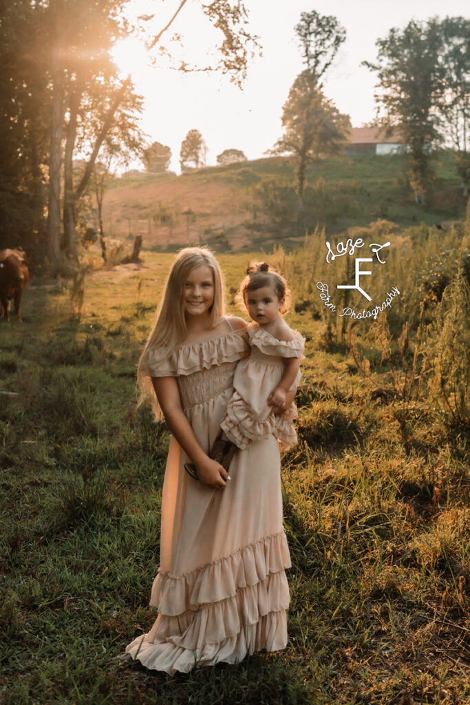 older girl holding little girl