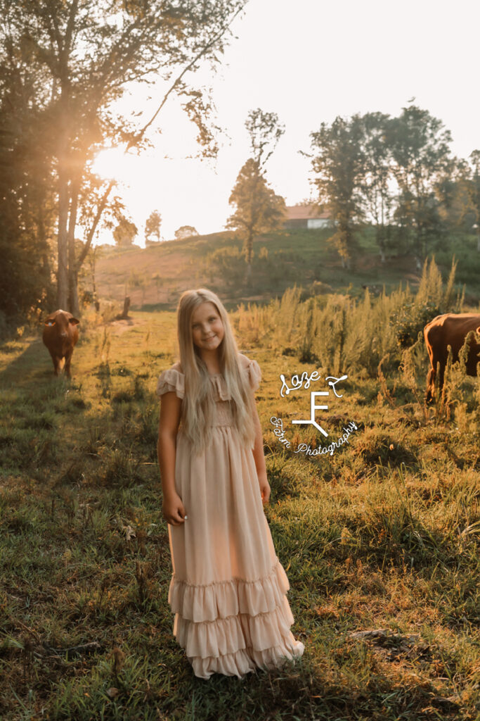older girl in tan dress with cows