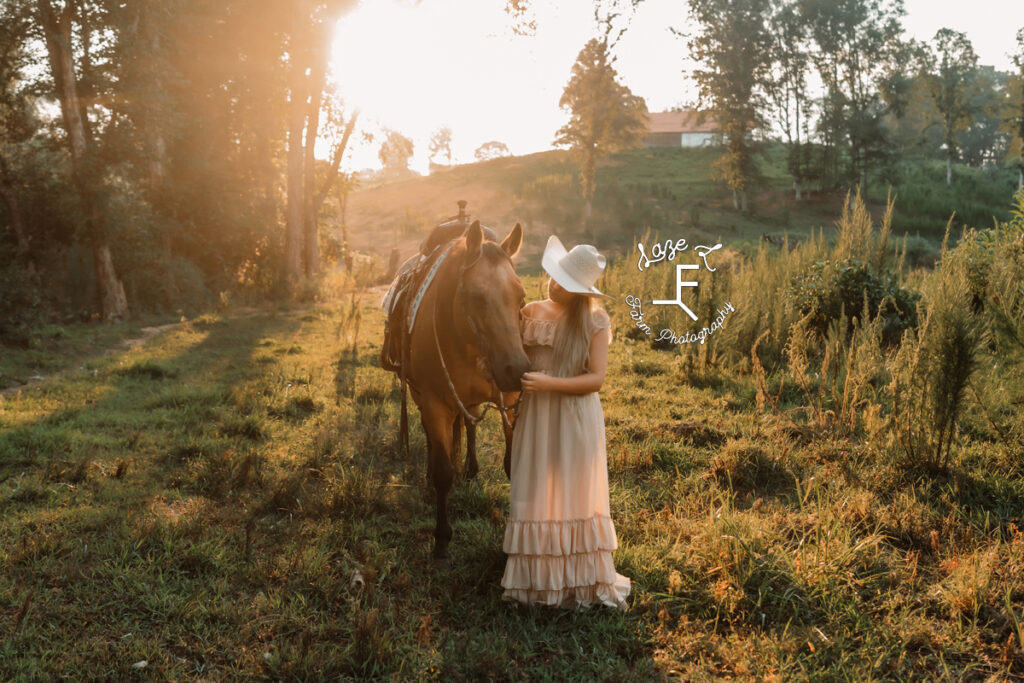 blond cowgirl with buckskin horse