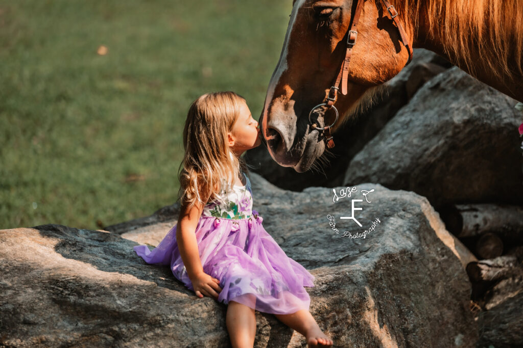 little girl kissing horse