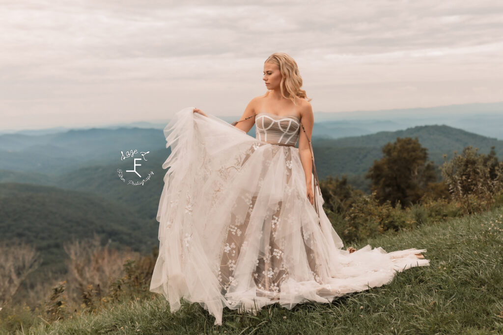model in front of the mountains tossing end of dress