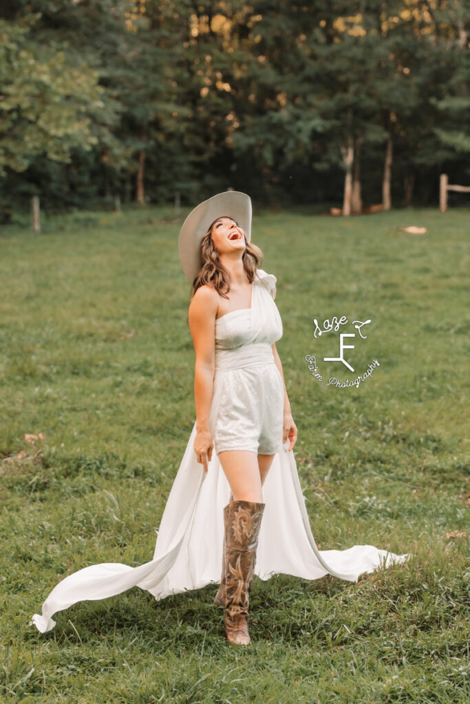 cowgirl bride in romper laughing