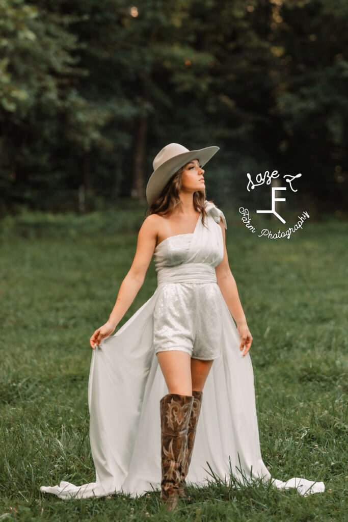 cowgirl bride holding train of romper looking right