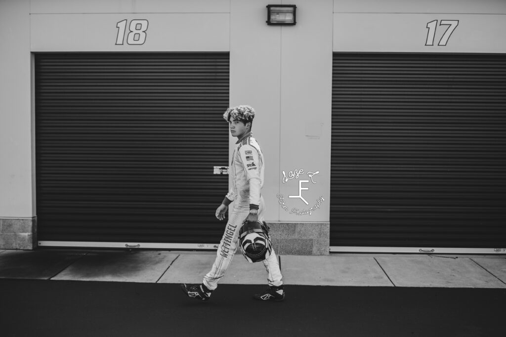 tyler walking in front of garage bays in black and white