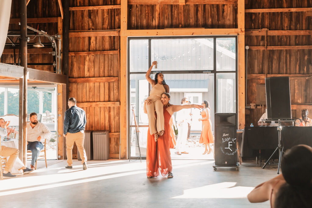 bridal party entrance with one girl holding another on her shoulder