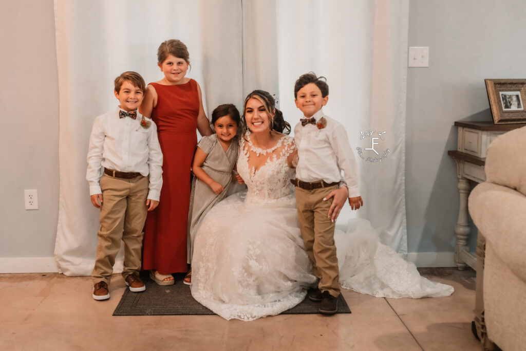 bride with flower girls and ring bearers