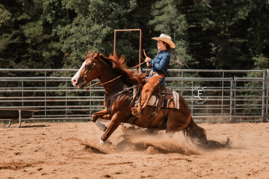 cowgirl with her horse reining stop