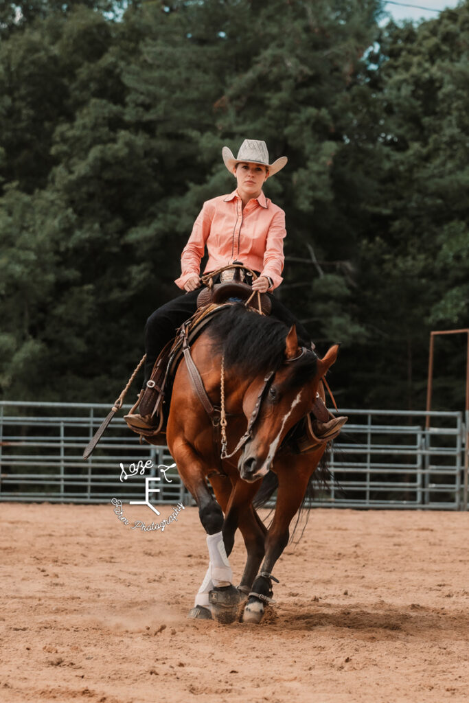 cowgirl riding mare doing reining spin
