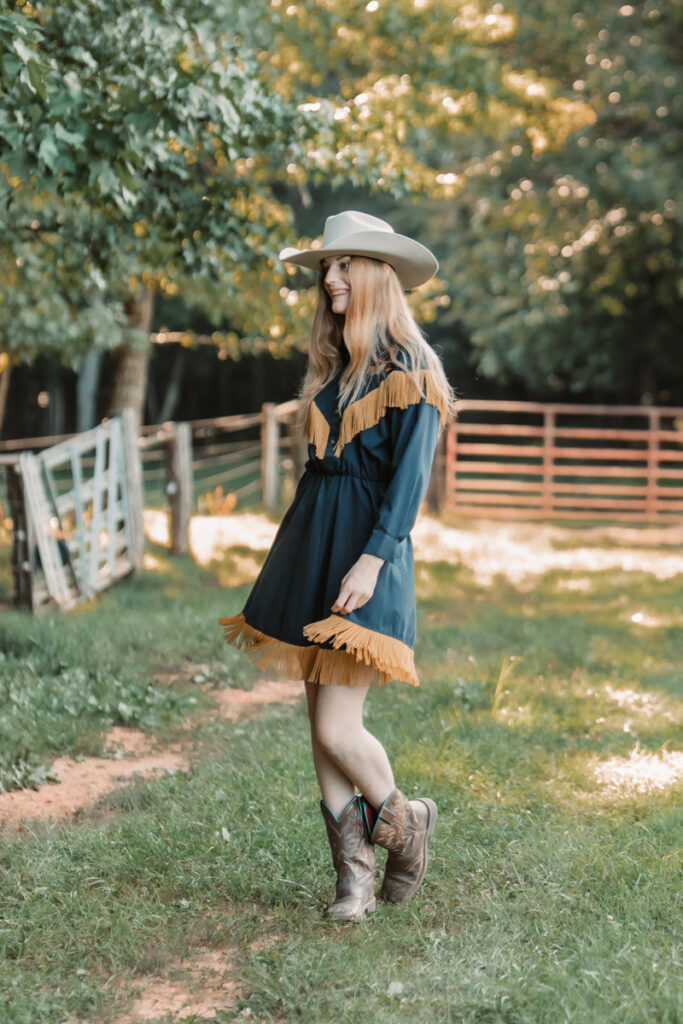 cowgirl in vintage blue dress with gold fringe