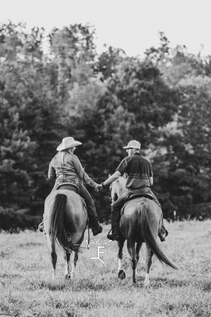 husband and wife on horse back in black and white