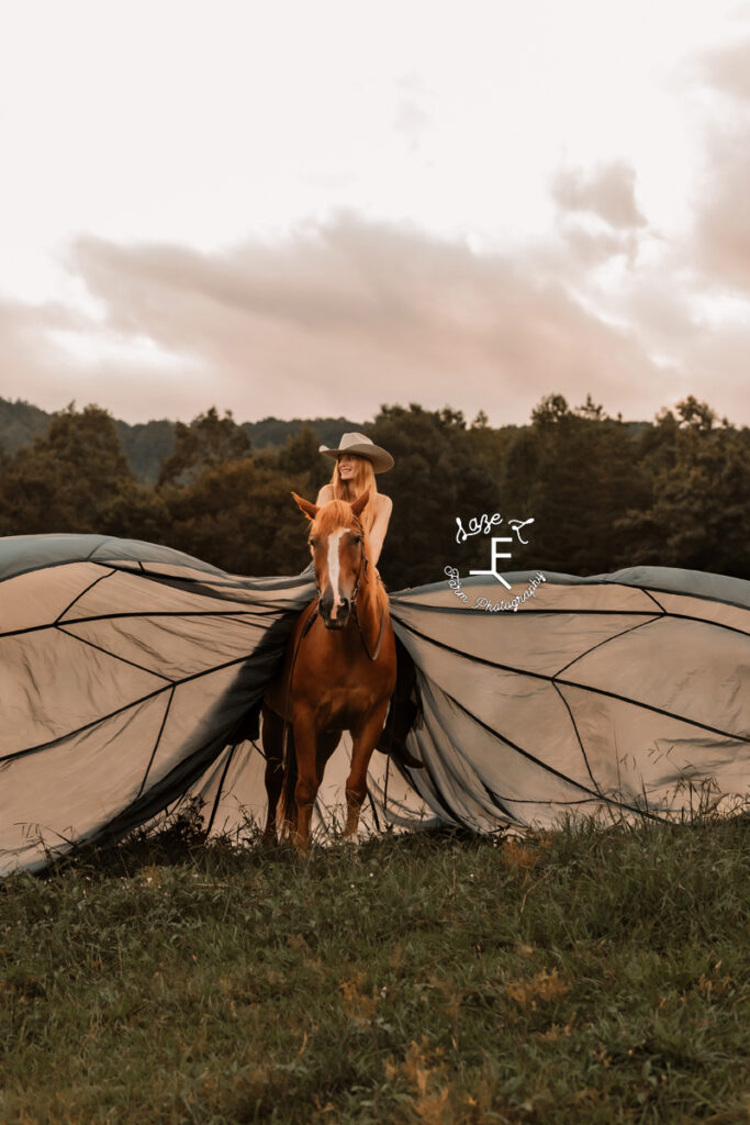 cowgirl on horse back in parachute dress