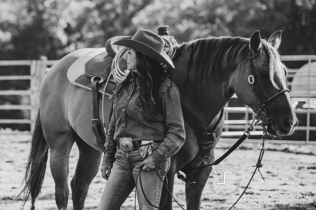 cowgirl with her horse in black and white