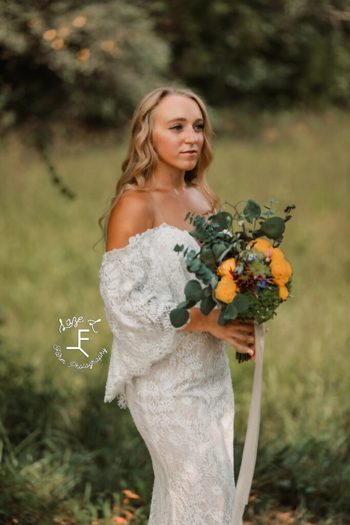 sam in bridal gown with orange flowers