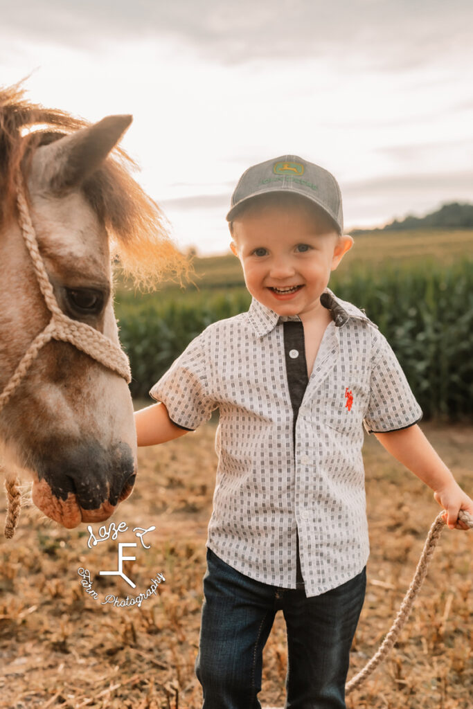 little boy in hat with his pony