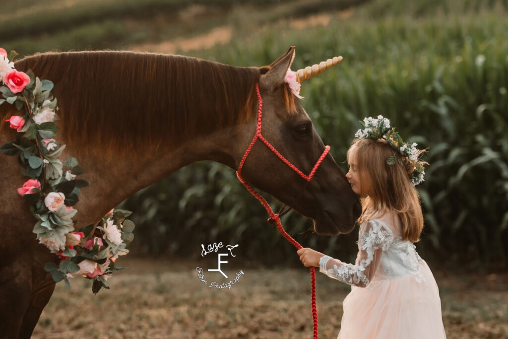 little sister kissing her unicorn horse