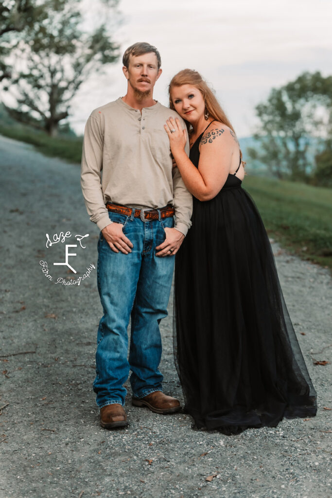 couple standing on dirt road