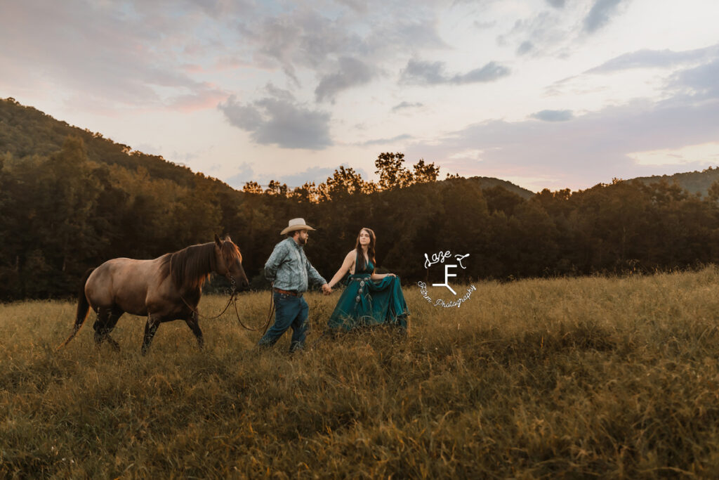 cowboy and fiancé walking with horse