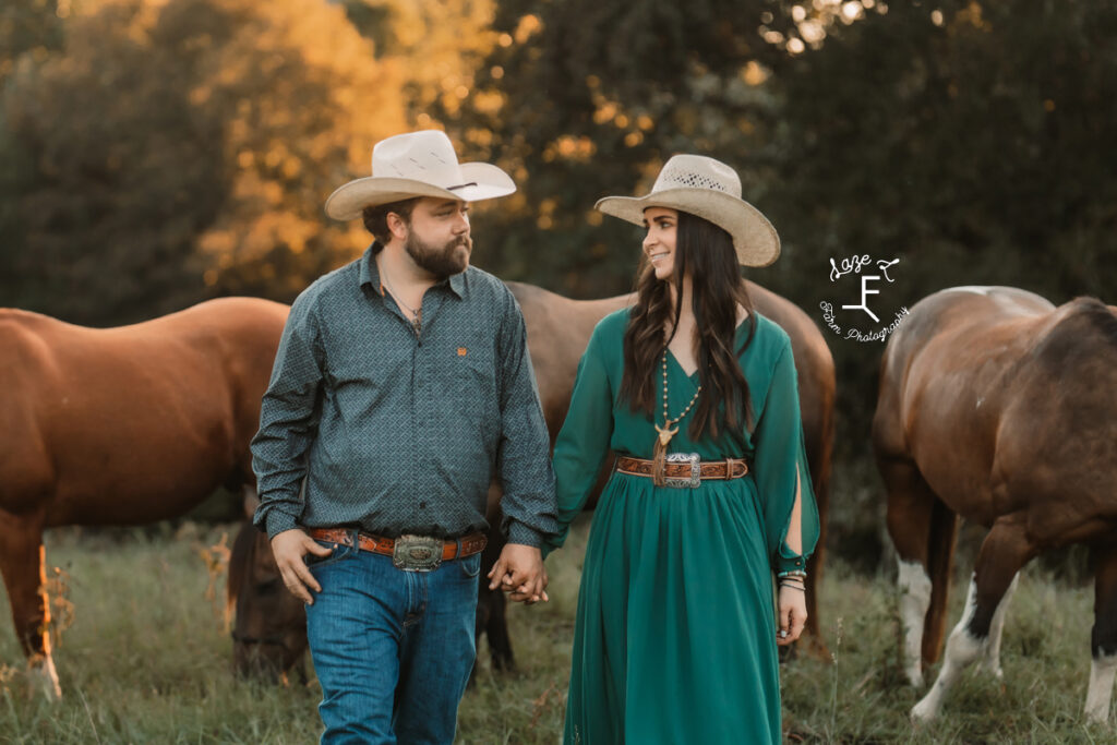 cowboy and cowgirl walking holding hands