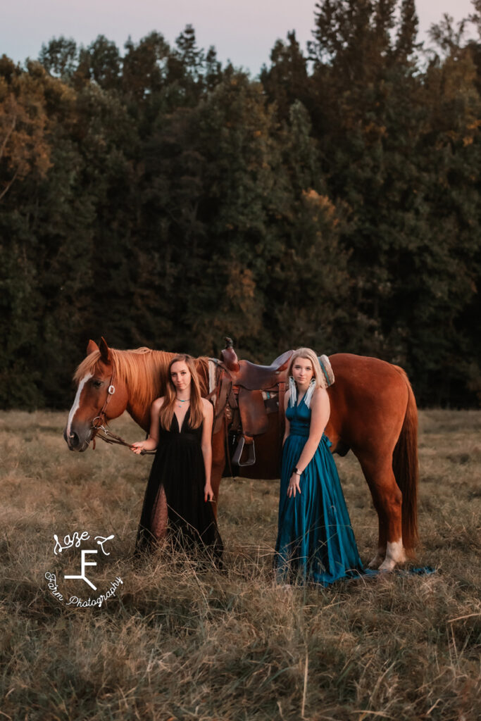 both models standing in dresses with Belgium cross horse