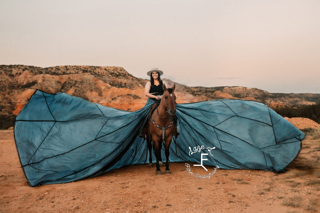 brunette cowgirl on horse wearing parachute dress