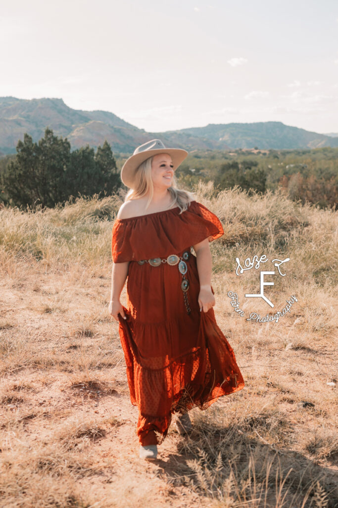 cowgirl in rust off shoulder dress