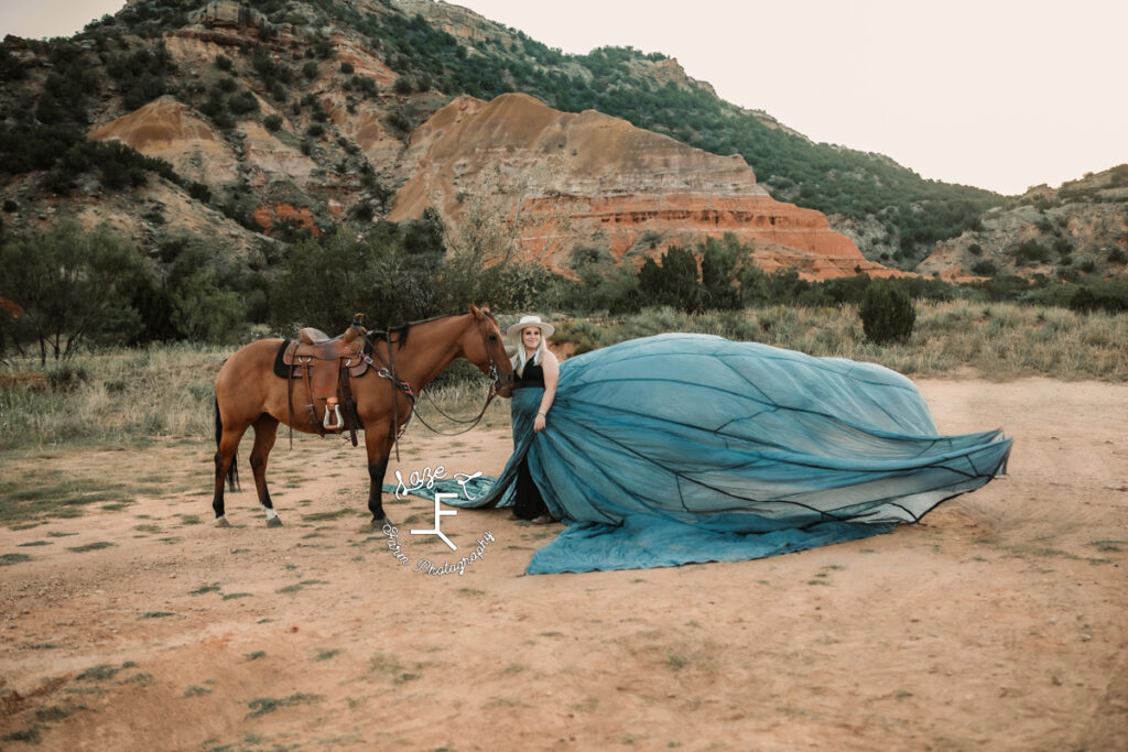 blond cowgirl in parachute dress with horse