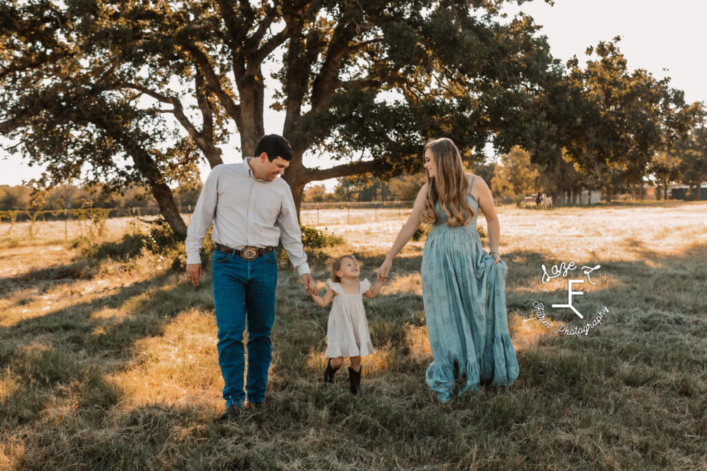 mom and dad with daughter walking