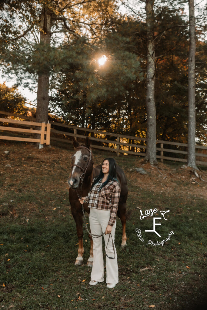 sister in plaid looking at horse