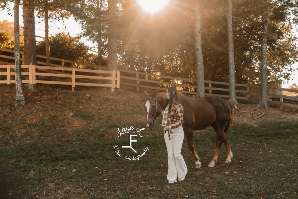 sister in plaid walking with her horse