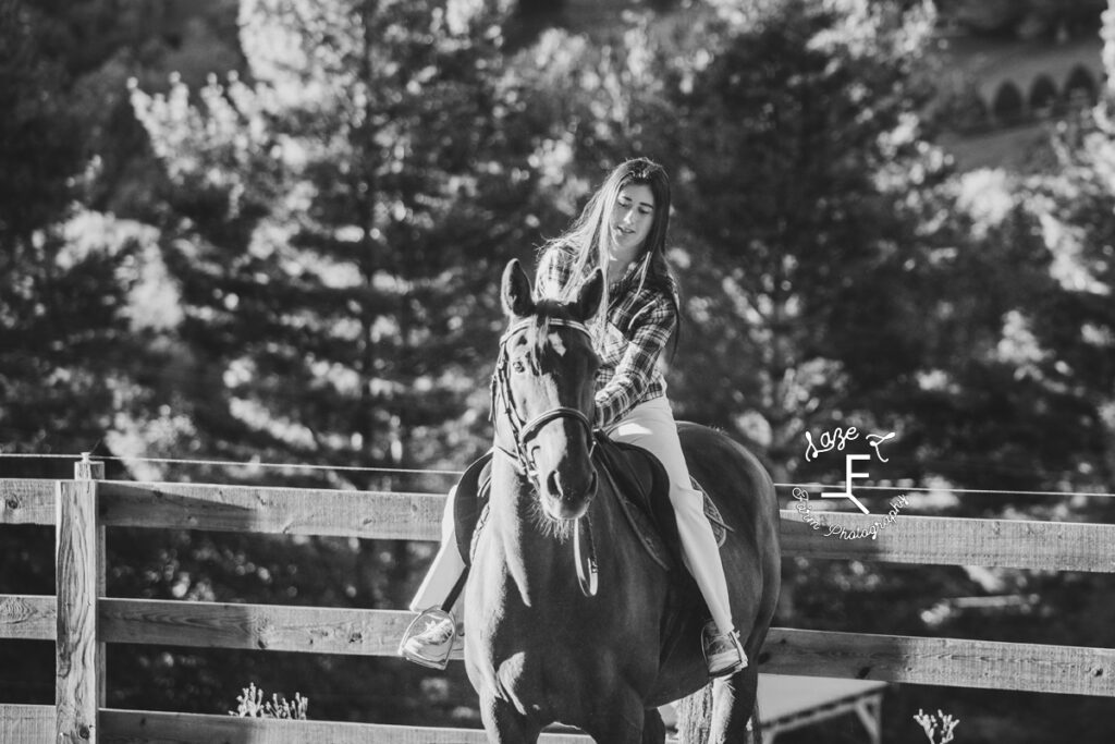 sister in plaid on her horse in black and white
