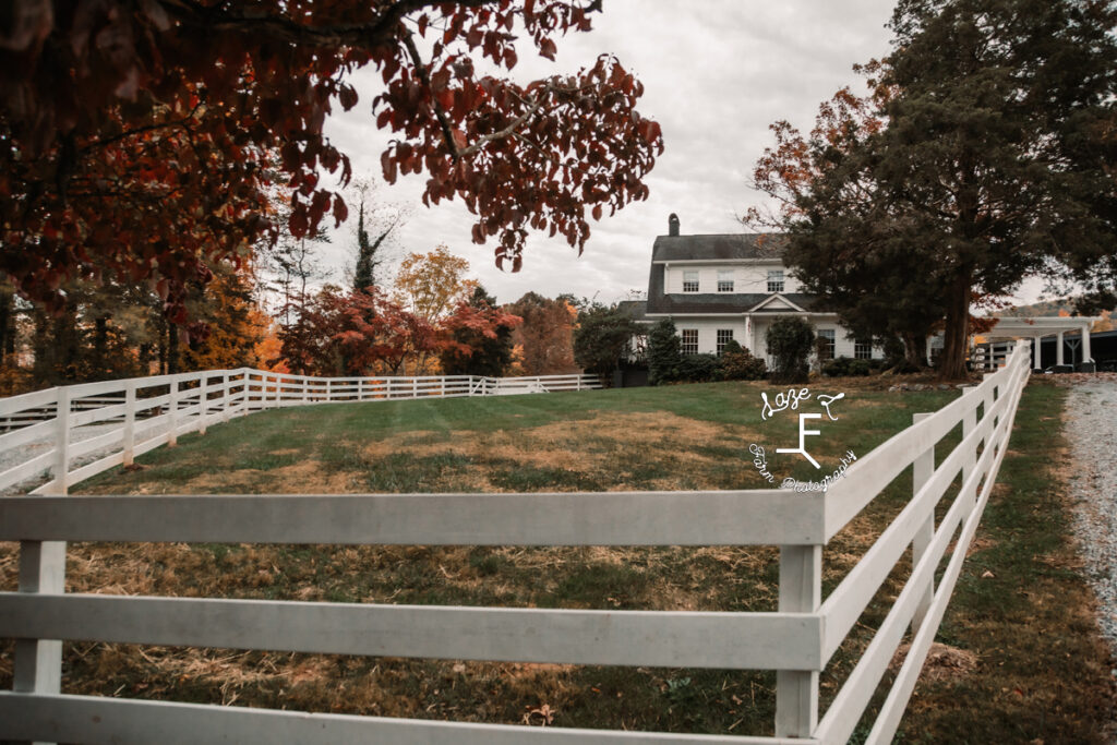 farmhouse with white fence