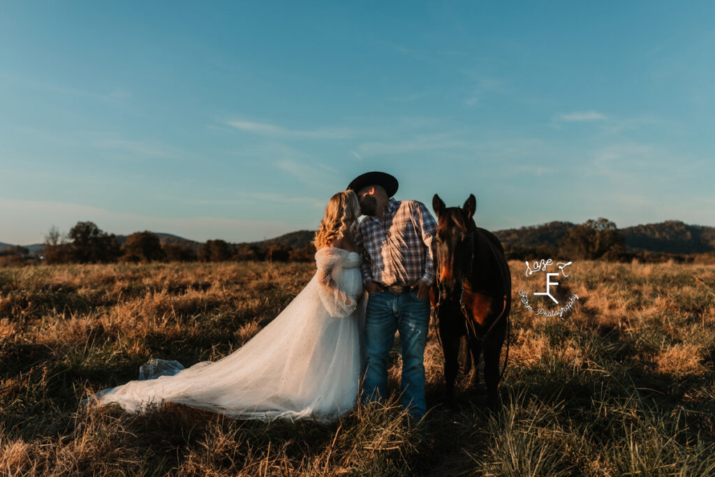 cowboy with wife in white long dress and horse