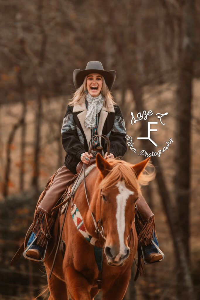 Cowgirl riding towards camera and laughing