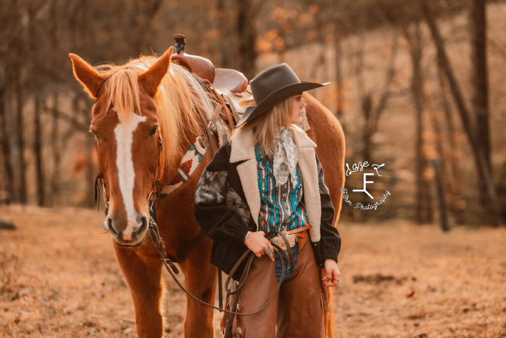 Cowgirl looking to the right in chaps and winter coat