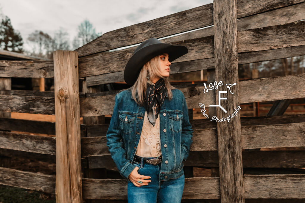 Cowgirl at cattle chute in jean jacket