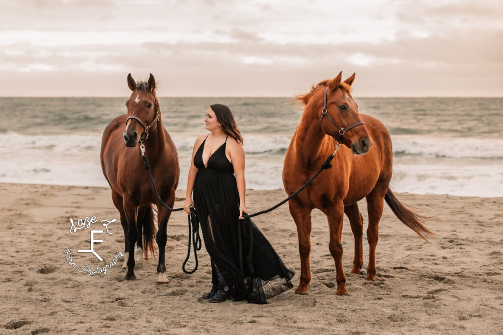 Cowgirl with both horses on the beach