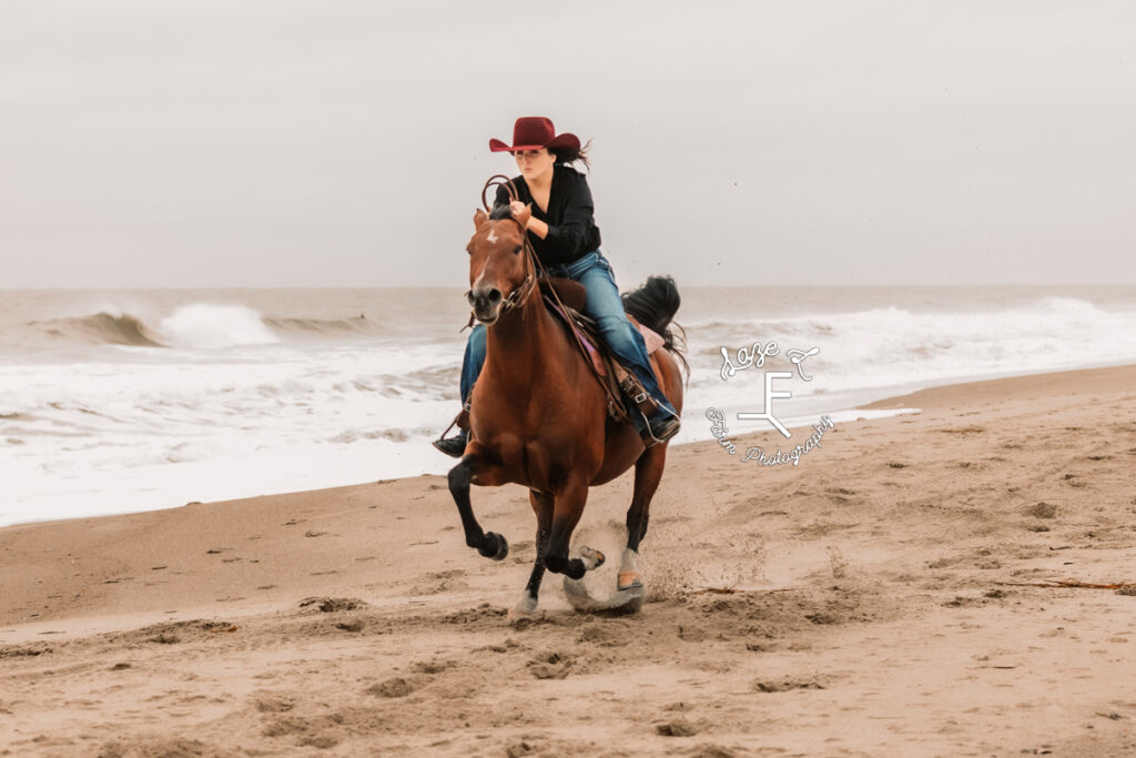 cowgirl galloping down the beach