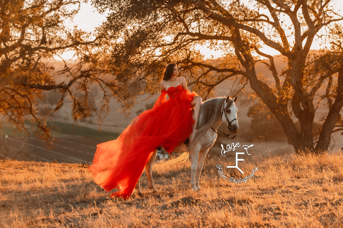 model in red dress riding Andalusian