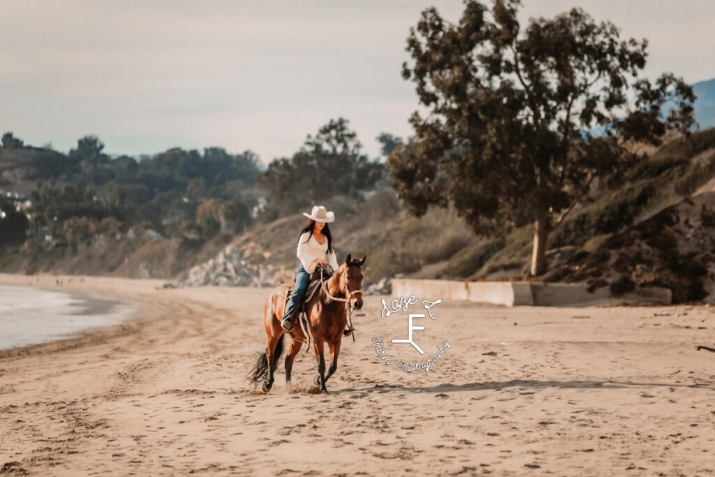 cowgirl riding on beach in CA