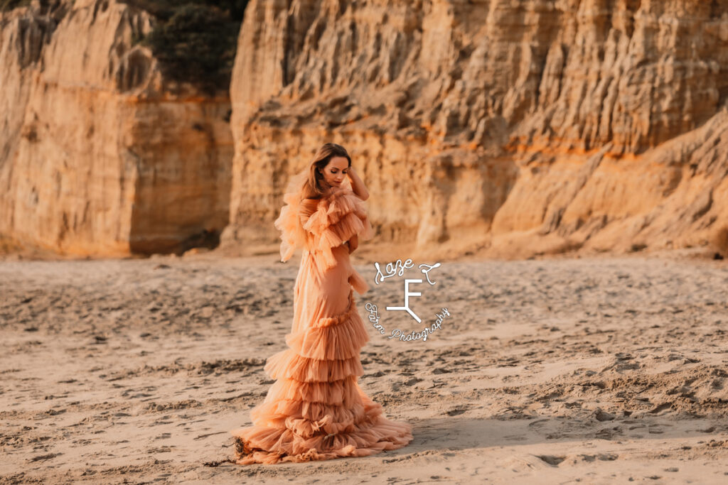 model in orange dress on beach