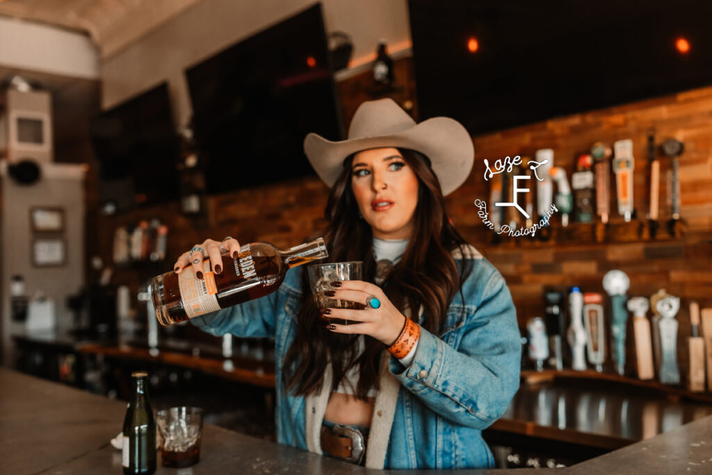 Cowgirl pouring Oak & Eden wiskey