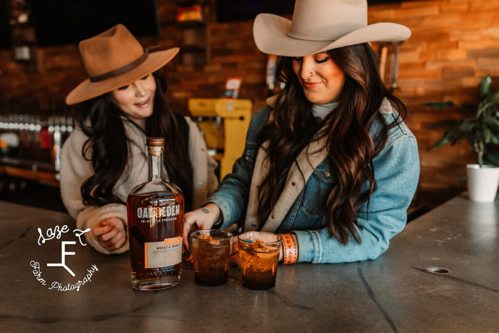 2 cowgirls talking over whiskey