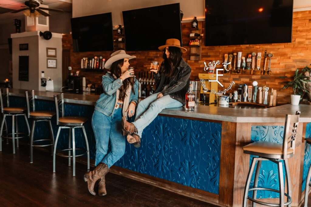 2 cowgirls at the bar talking