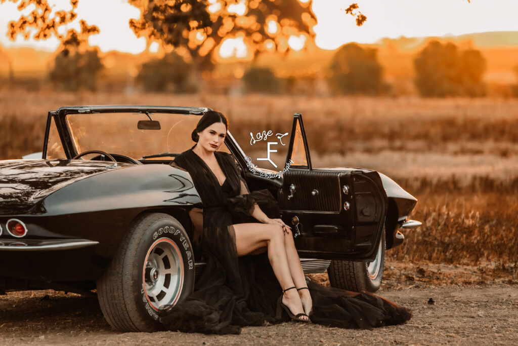 model sitting in corvette with dress flowing out of car