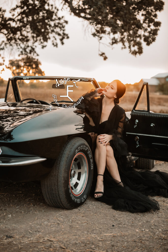 model sitting in corvette with legs crossed looking left