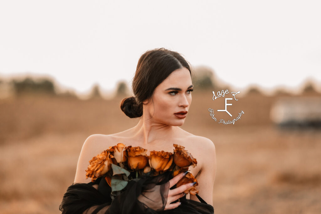 model with orange flowers looking right