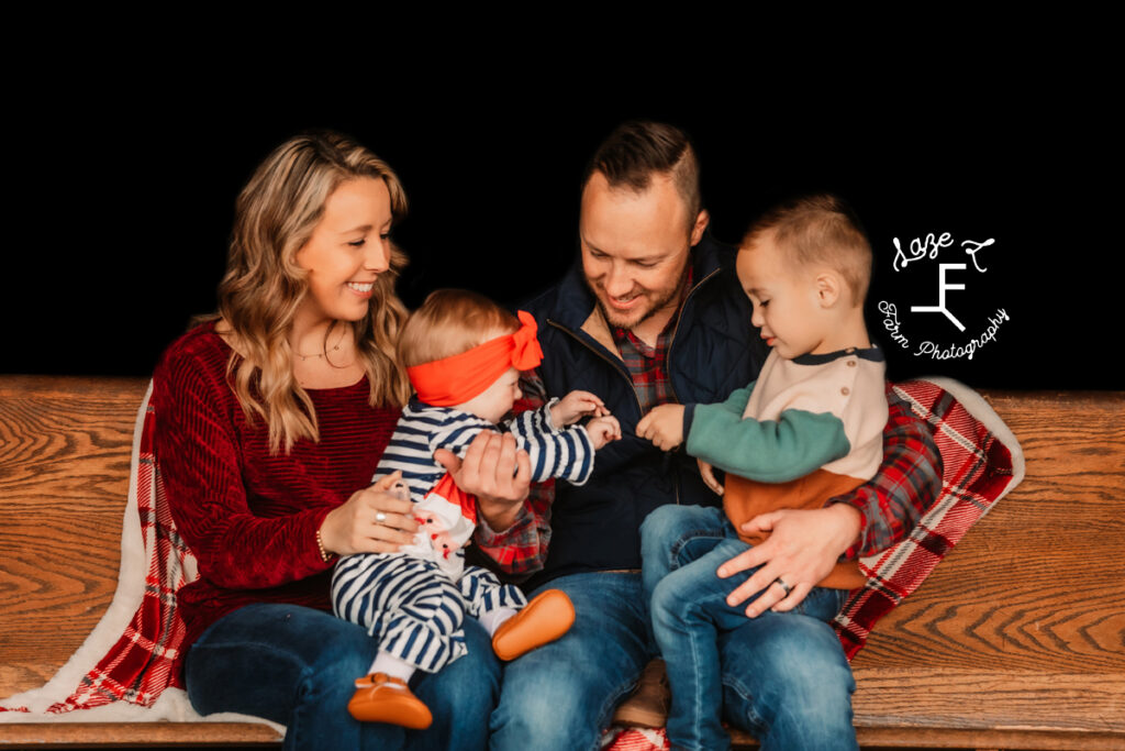 Mom and Dad with 2 little kids playing and laughing