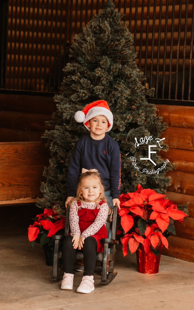 brother and sister in front of Christmas tree