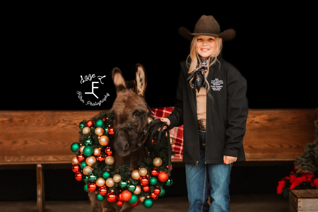 Payton with the donkey wearing a wreath